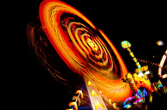 Abstract long exposure of spinning carnival lights at night