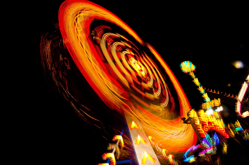 Abstract long exposure of spinning carnival lights at night