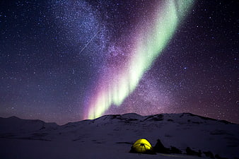 Aurora Borealis over Snowy Mountain Campsite at Night