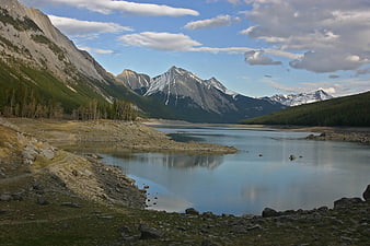 Scenic mountain lake landscape with snow-capped peaks and forest