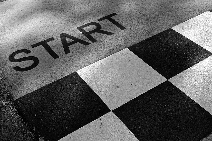 Black and white start line on racetrack with checkered pattern