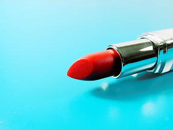 Close-up of red lipstick on bright blue background