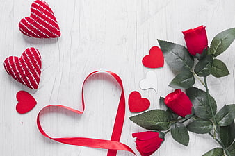 Valentine's Day Flat Lay with Red Roses and Knitted Hearts