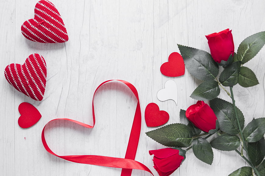 Valentine's Day Flat Lay with Red Roses and Knitted Hearts