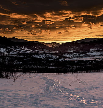 Dramatic Winter Sunset Over Snowy Mountain Valley