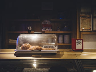 Croissants in a bakery display case with warm lighting