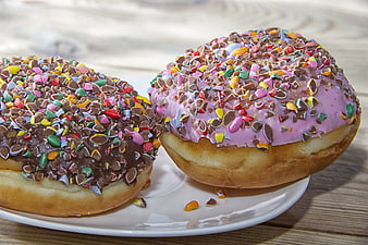 Two Sprinkle Topped Donuts on White Plate
