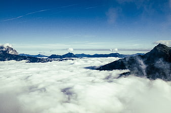 Majestic mountain peaks rising above a sea of clouds