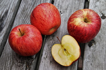 Fresh Red Apples And Sliced Half On Weathered Wooden Planks