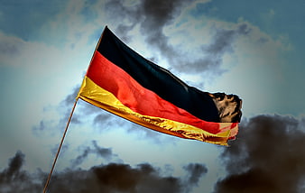 German flag waving against dramatic cloudy sky