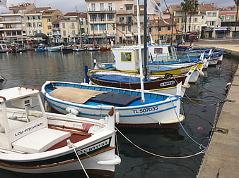 Colorful fishing boats docked in a French harbor