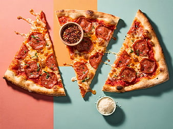 Pepperoni Pizza Slices on Colorful Background with Spices