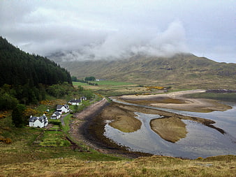 Scenic coastal village with white houses by a river estuary