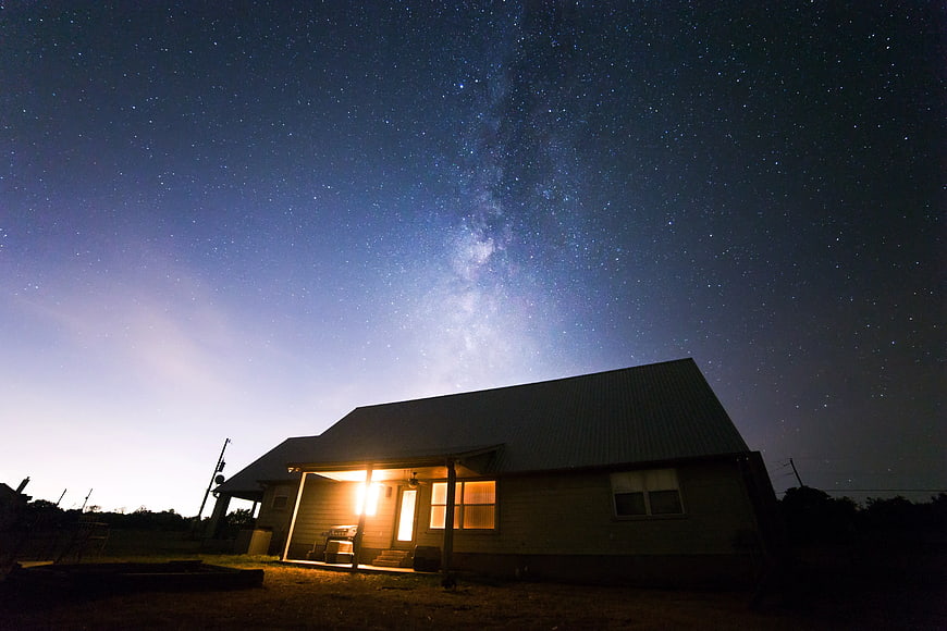 Rustic House Under Milky Way Starry Night Sky