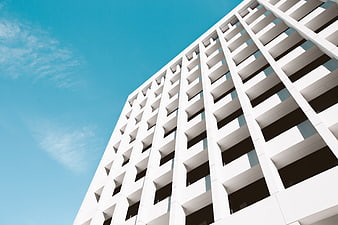 Modern White Apartment Building Against Blue Sky