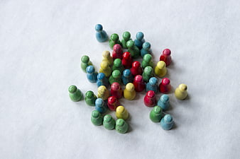 Colorful wooden game pieces on white background