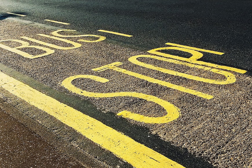 Yellow Bus Stop Road Markings on Asphalt