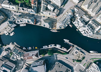 Aerial top-down view of a European city harbor with boats