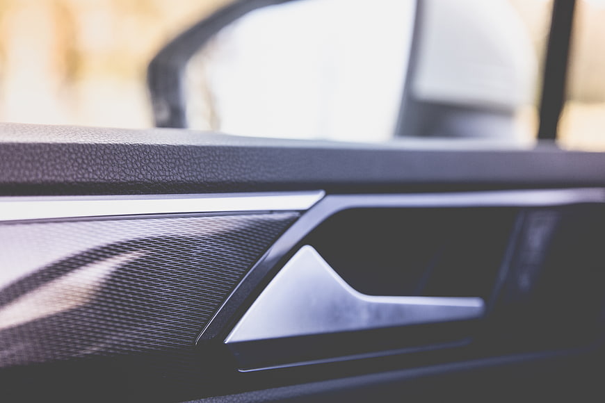 Close-up of modern car door handle and interior trim