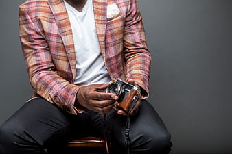 Man in Plaid Blazer Holding Vintage Camera