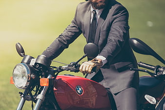 Businessman in Suit Riding Red BMW Motorcycle