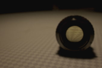 Close-up of camera lens on checkered surface
