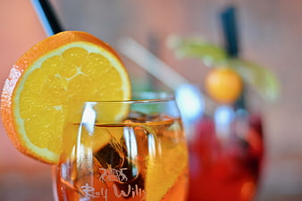 Close-up of iced cocktail with orange slice garnish