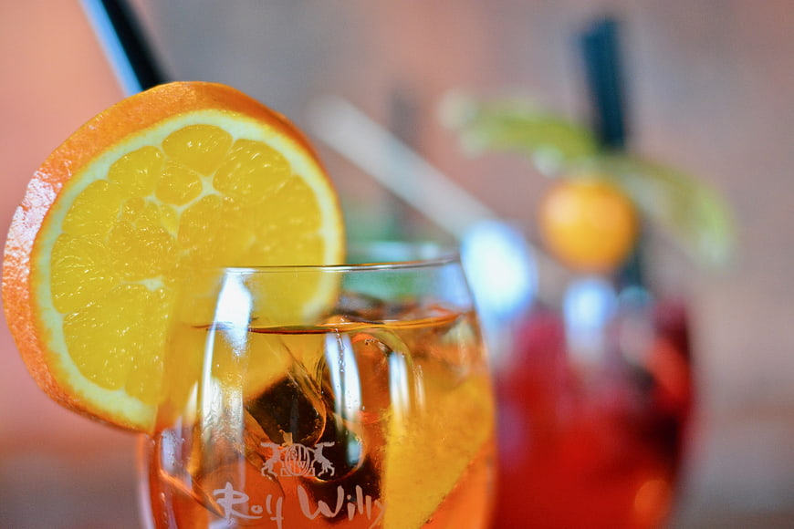 Close-up of iced cocktail with orange slice garnish