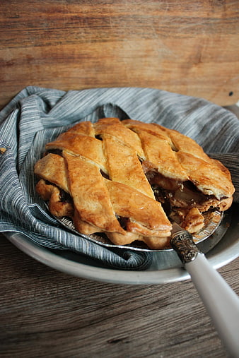 Homemade Apple Pie with Lattice Crust on Wooden Table