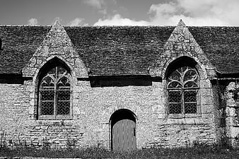 Black and white gothic church facade with stone windows