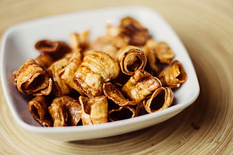 Crispy Banana Chips in White Bowl on Wooden Table