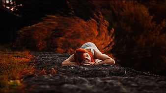 Redhead Woman Sleeping on Ground in Autumn Forest