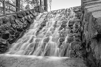 Black and white long exposure mini waterfall on stone steps