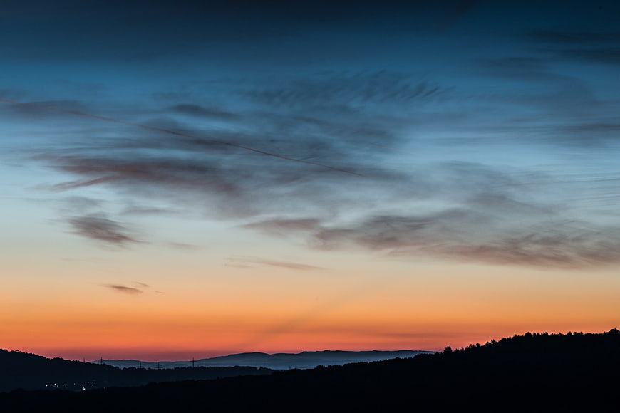 Dramatic Sunrise Sky Over Silhouetted Hills