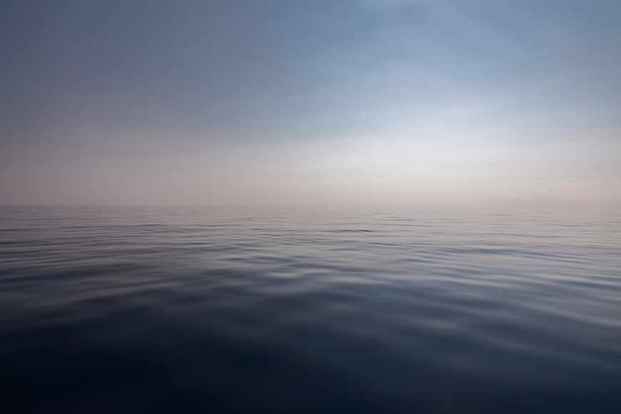Minimalist Misty Ocean Horizon With Calm Water Surface