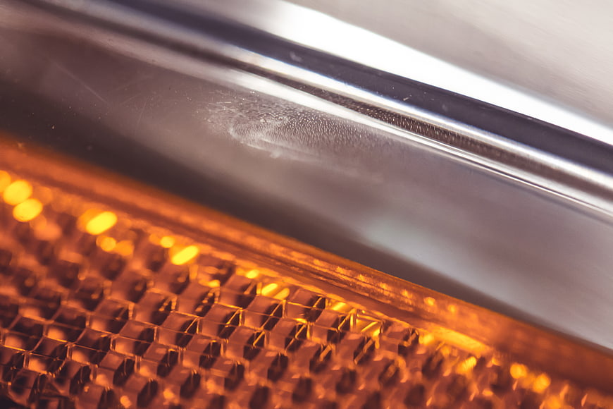 Close-up of glowing orange car turn signal reflector