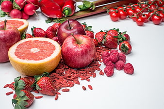Fresh red fruits and berries on white background