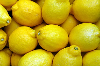 Close-up of fresh yellow lemons piled together