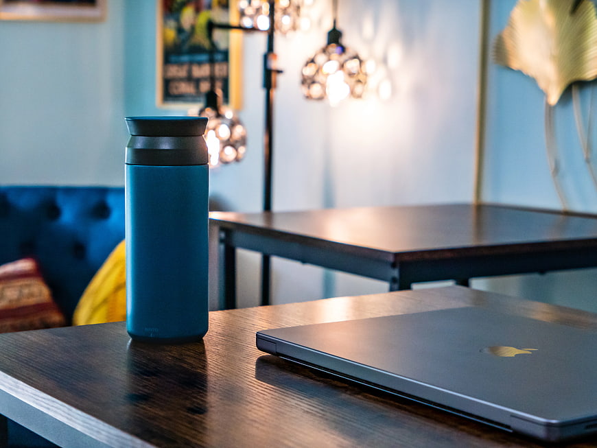 Blue Tumbler and Laptop on Wooden Table