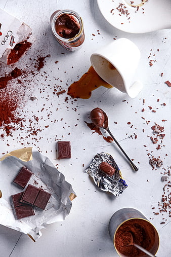 Overhead view of messy chocolate ingredients and cocoa powder