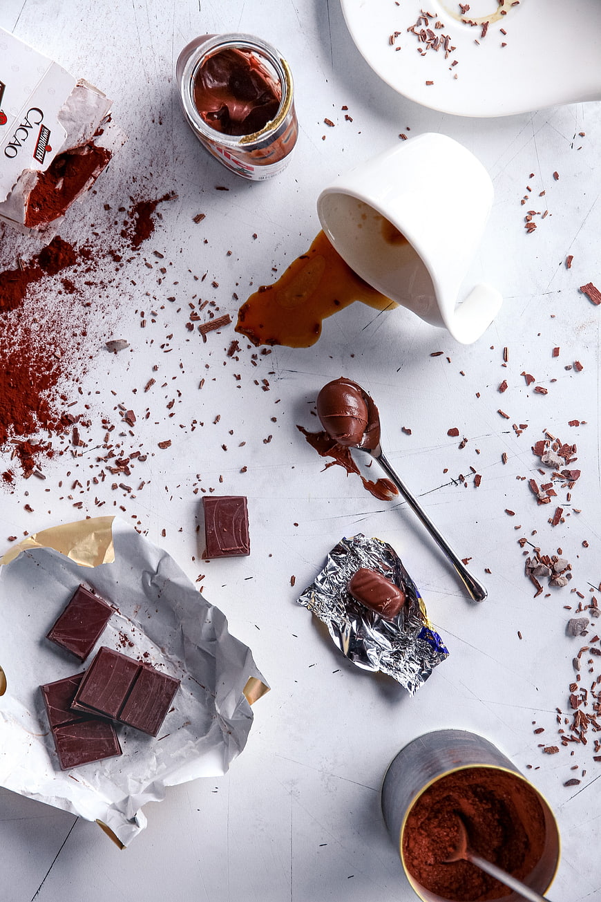 Overhead view of messy chocolate ingredients and cocoa powder