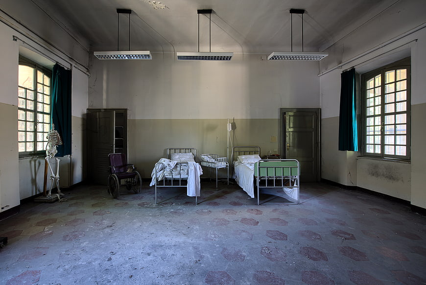 Abandoned Hospital Ward with Vintage Beds and Wheelchair