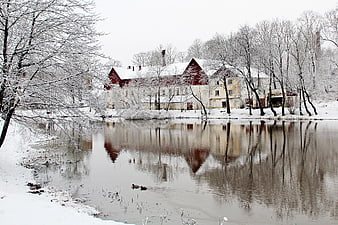 Snowy Winter Landscape with Red Mill and Frozen Pond