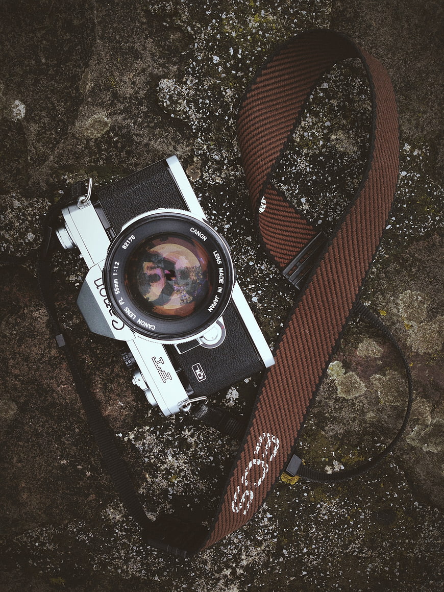 Vintage Canon AE-1 Camera on Textured Rock Surface