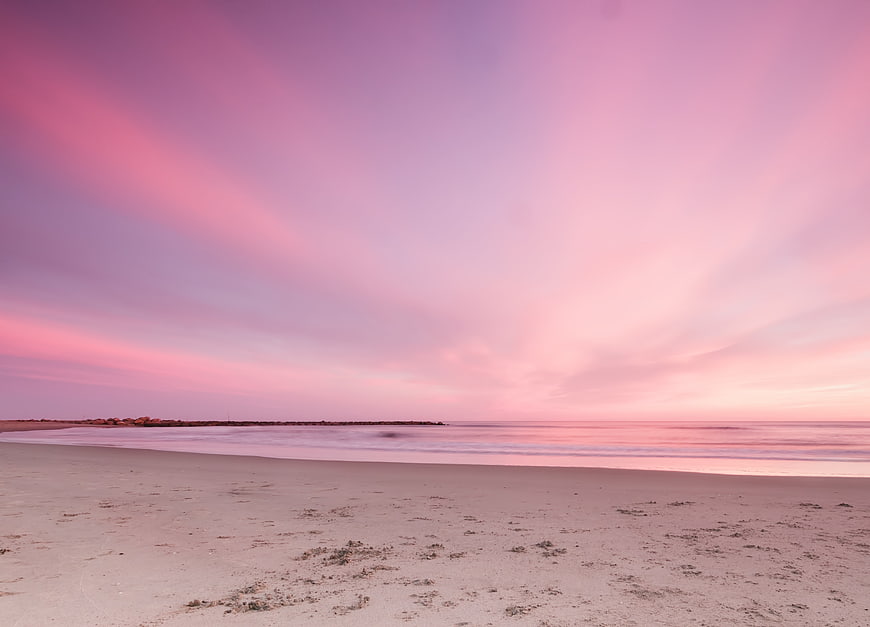 Pink Sunset Sky Over Calm Beach Horizon