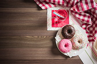 Top View of Colorful Donuts and Drink on Wooden Table