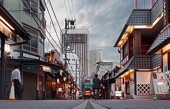 Low angle street view of traditional Japanese shops and modern buildings