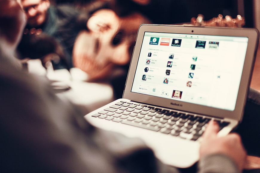 Person using MacBook Air laptop in casual setting