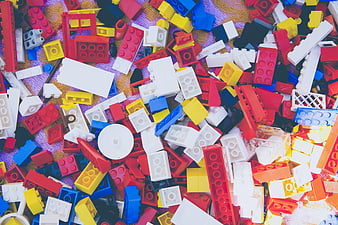 Colorful pile of scattered building blocks on a patterned surface