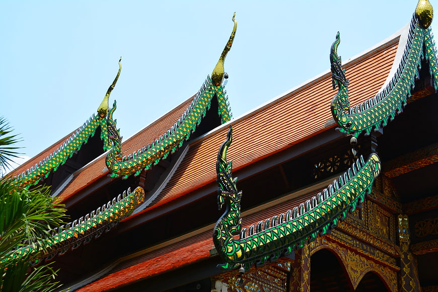 Traditional Thai Temple Roof with Green Naga Serpents